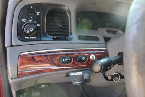 2002 Mercury Grand Marquis - The interior of a 2002 Mercury Grand Marquis features wood grain trim and a digital display.