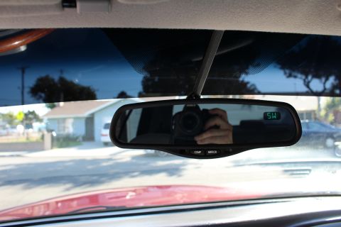 2002 Mercury Grand Marquis - Reflection in the rearview mirror shows the photographer and a digital display.