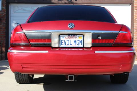 2002 Mercury Grand Marquis - Rear view of a red 2002 Mercury Grand Marquis, a California license plate that reads EVIL MGM.