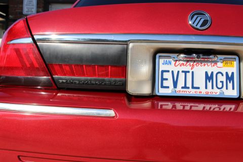 2002 Mercury Grand Marquis - Rear view of a red 2002 Mercury Grand Marquis showing the taillight and license plate.