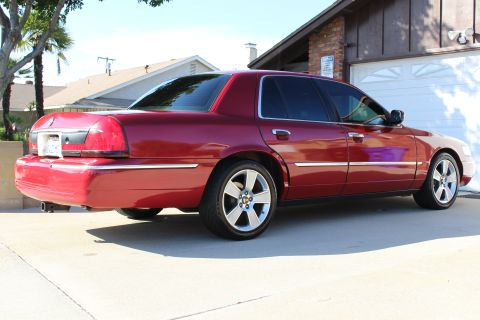 2002 Mercury Grand Marquis - Rear 3/4 view of a red 2002 Mercury Grand Marquis parked in a driveway.