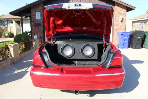 2002 Mercury Grand Marquis - Rear view of a red 2002 Mercury Grand Marquis, its trunk with a custom subwoofer installation.