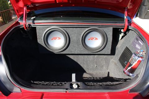 2002 Mercury Grand Marquis - Trunk of a red car with custom audio equipment installed.