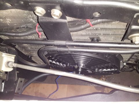 1976 Ford Ranchero - Close-up view of an electric cooling fan mounted in front of a vehicle's radiator.