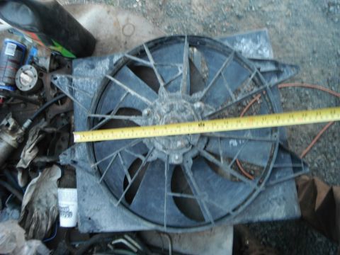 1980 Ford Bronco - Radiator fan assembly is measured with a tape measure.