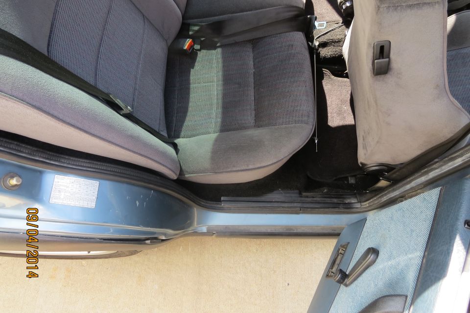 Car interior showing front seats and door panel. Date stamp on door reads 09/04/2014