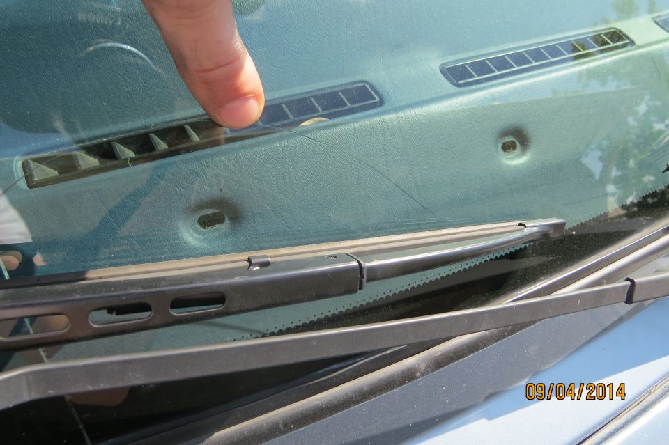 Dashboard vents and windshield with a finger pointing