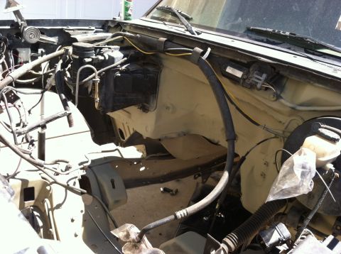 1995 Ford Bronco - Disassembled engine bay with visible hoses, wiring, and firewall components.