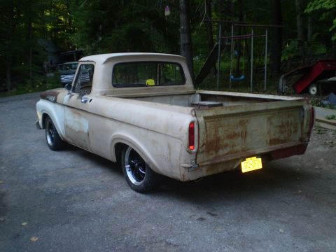 1979 Ford Bronco - Weathered 1965 Ford F-100 pickup truck with custom wheels and lowered stance.