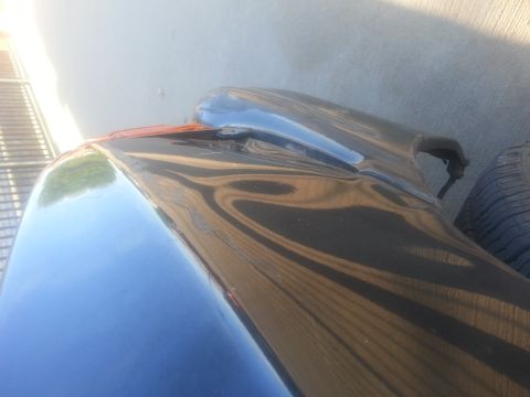 1991 Ford Festiva - The rear fender and tire of a car are visible in this close-up shot.