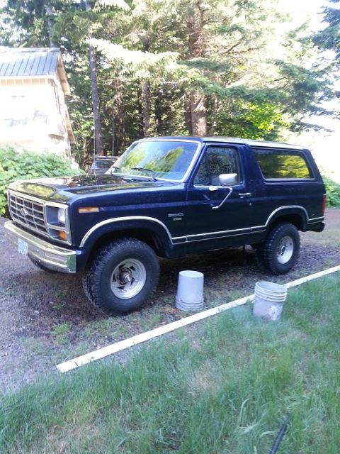 1986 Ford Bronco - This Ford Bronco features a chrome grille and trim, with a dark blue exterior.