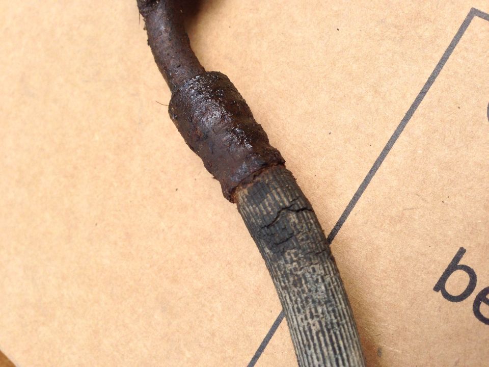 Worn brake hose with cracked rubber and metal braiding