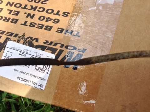 1979 Ford Bronco - A close-up of a dipstick lies on a cardboard box with shipping information visible.