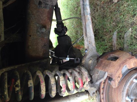 1979 Ford Bronco - The front suspension and brake components show significant rust and wear.