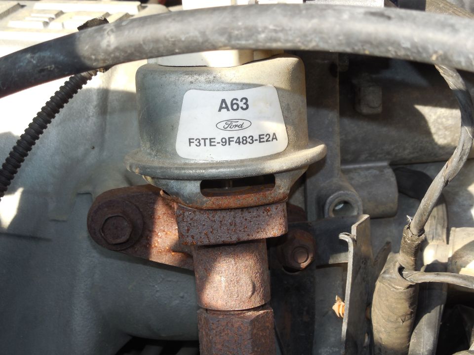 Ford EGR valve part F3TE-9F483-E2A with A63 label mounted in engine bay