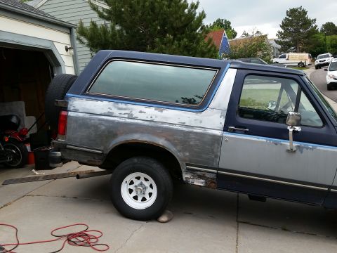 1988 Ford Bronco - This Ford Bronco appears to be undergoing bodywork, with primer and rust visible on its panels.
