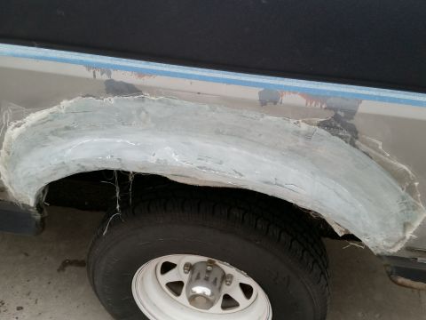 1988 Ford Bronco - Fiberglass is being applied to a truck's damaged wheel well area.