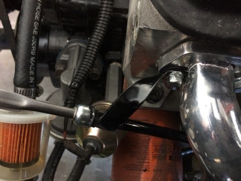 Engine bay detail showing a fuel filter, fuel line, and part of an exhaust manifold