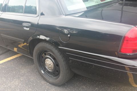 2009 Ford Crown Victoria - Side view of a black 2009 Ford Crown Victoria with steel wheels.