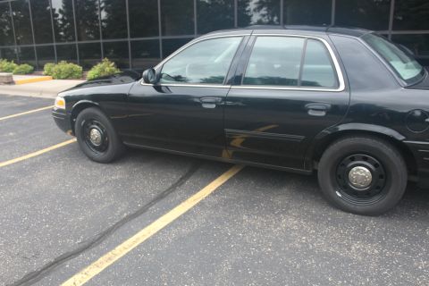 2009 Ford Crown Victoria - Side view of a black 2009 Ford Crown Victoria parked in a lot.