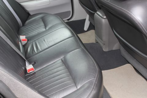 2009 Ford Crown Victoria - Rear interior view of a 2009 Ford Crown Victoria showing the leather seats and console.