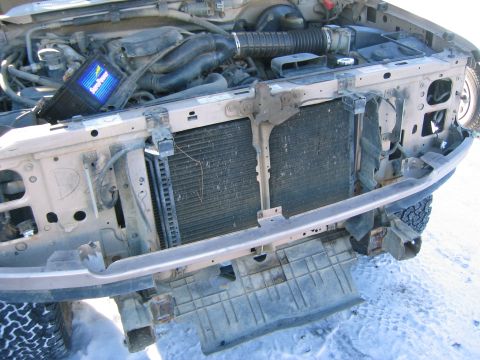 1996 Ford Bronco - Front end of a 1996 Ford Bronco with the radiator removed, revealing the engine bay.