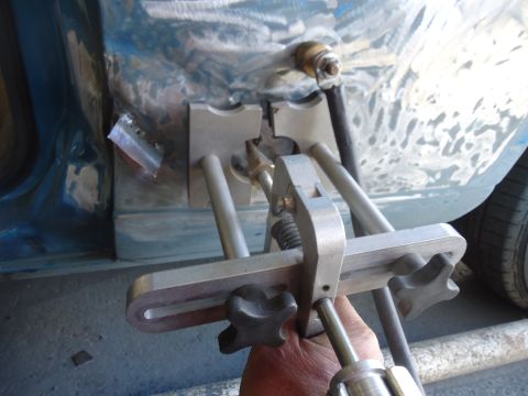 1994 Ford Thunderbird - A dent pulling tool is being used on a damaged car body panel during repairs.