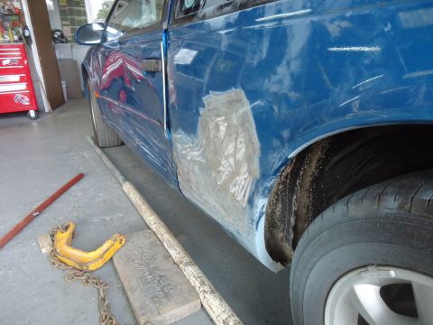 1994 Ford Thunderbird - Car door undergoing body repair, showing applied filler and primer before paint.