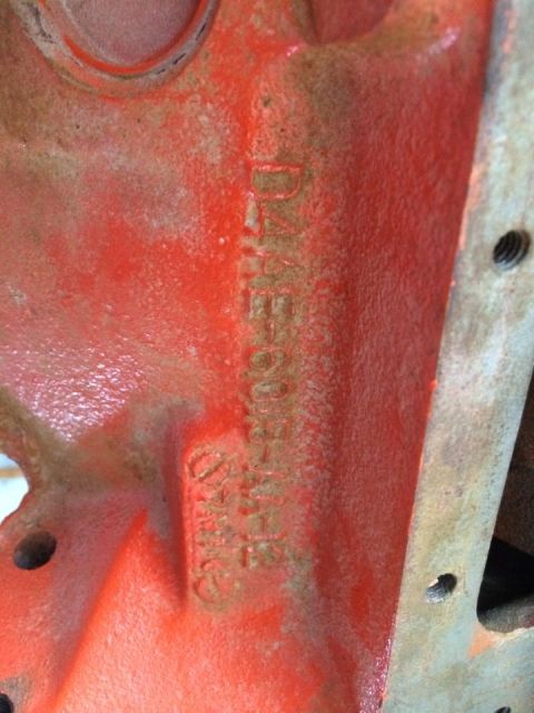 1994 Ford Bronco - Close-up of an orange engine block casting showing stamped identification numbers.