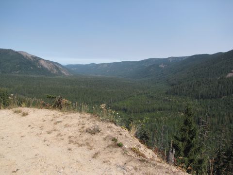 1992 Ford F-150 - Expansive view of a forested mountain valley, likely taken from an overlook on a clear day.