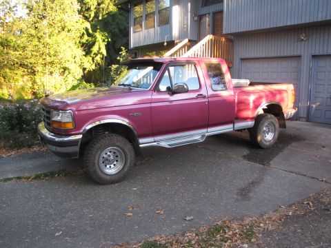1992 Ford F-150 - Maroon 1992 Ford F-150 pickup truck with a crew cab and toolbox in the bed.