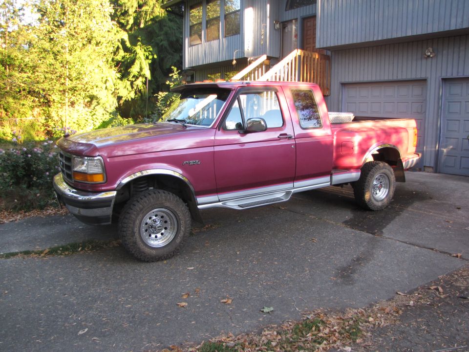 Maroon 1992 Ford F-150 pickup truck parked in driveway. It has a crew cab and a toolbox in the bed