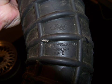 1995 Mercury Grand Marquis - Close-up of a Ford air intake hose, part number F75-9R530-AD, made of EPDM.