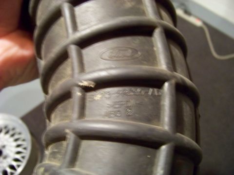 1995 Mercury Grand Marquis - Close-up of a Ford branded air intake hose showing part numbers and material type.