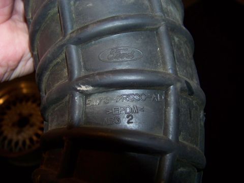1995 Mercury Grand Marquis - A black Ford air intake hose is shown, marked with part number F73-9R530-AD and EPDM material.
