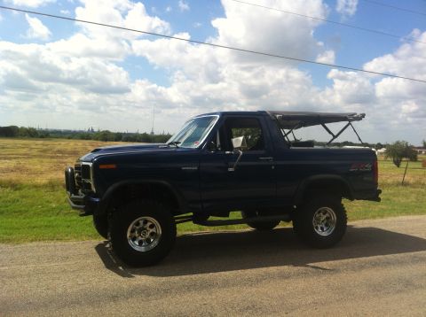 1982 Ford Bronco - This 1982 Ford Bronco is equipped with a soft top and lifted suspension, ready for off-road adventures.