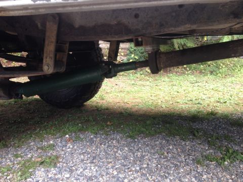 1971 Ford F-250 - A view of the undercarriage reveals the driveshaft and a tire, with the frame of the vehicle visible above.