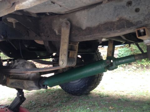 1971 Ford F-250 - The underside of a truck reveals a green driveshaft and rear axle assembly.