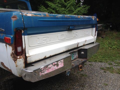 1971 Ford F-250 - The tailgate of a weathered 1971 Ford F-250 pickup truck shows the iconic "FORD" lettering.