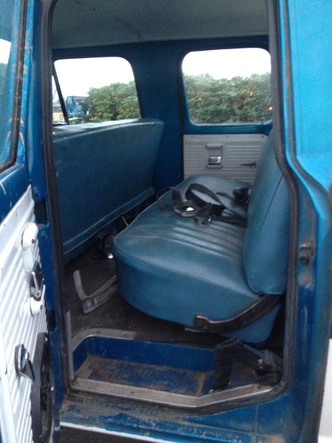 1971 Ford F-250 - View of the interior of a blue truck, showing the bench seat and door panel.