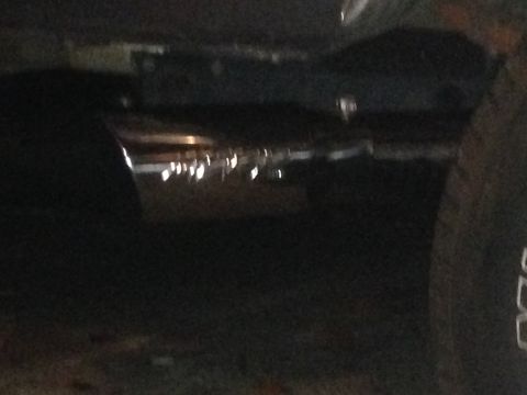 1988 Ford Bronco - A close-up view of a vehicle's exhaust pipe, reflecting lights.