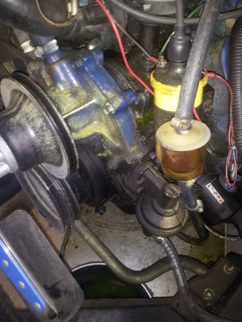 1968 Ford Mustang - Close-up of engine components including a fuel pump and ignition coil.