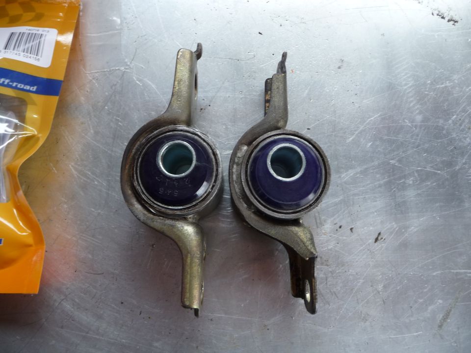 Two suspension bushings with blue polyurethane inserts