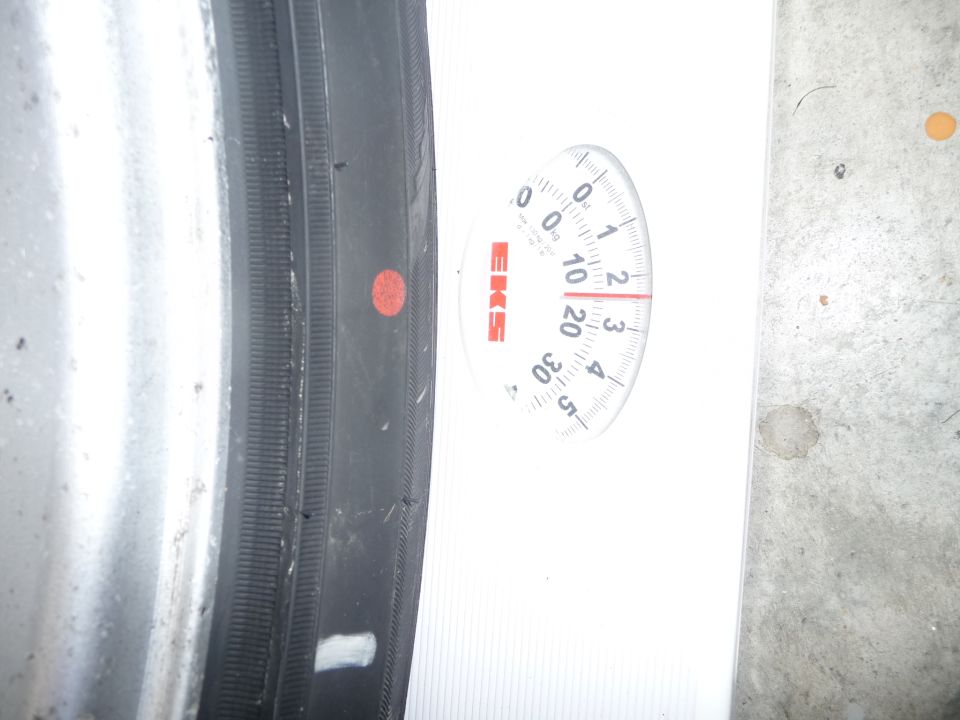 Tire on a scale showing approximately 10 pounds