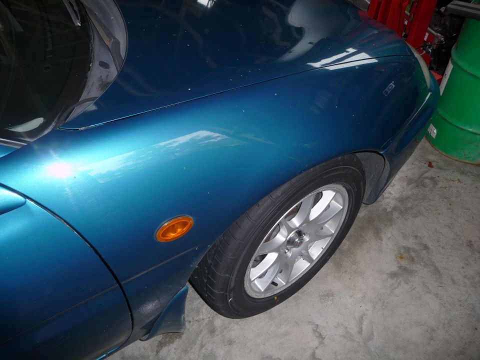 1993 Mazda MX-3 fender and wheel, blue paint, orange side marker light