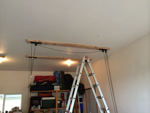 1989 Ford Bronco - A garage scene shows a pulley system installed on the ceiling and a ladder leaning against shelves.