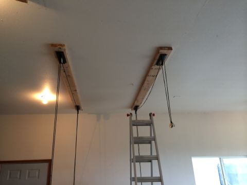 1989 Ford Bronco - A DIY hoist system is installed on the garage ceiling, wooden beams and pulley mechanisms.