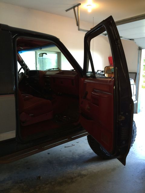 1989 Ford Bronco - Interior view of a 1989 Ford Bronco with the driver's side door open.