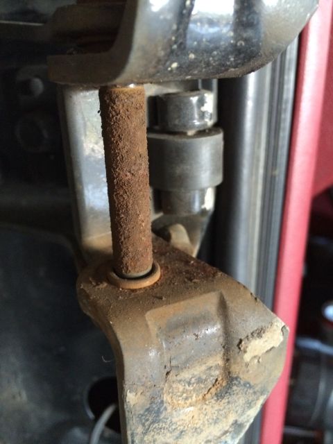 1989 Ford Bronco - Close-up of a rusted metal bracket and bolt assembly.