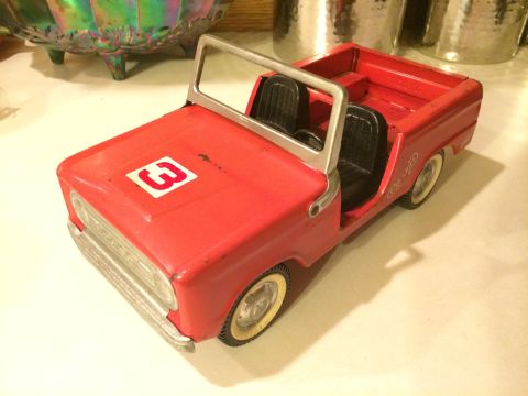 1989 Ford Bronco - This red toy jeep features a white number 3 graphic on its hood and white-walled tires.